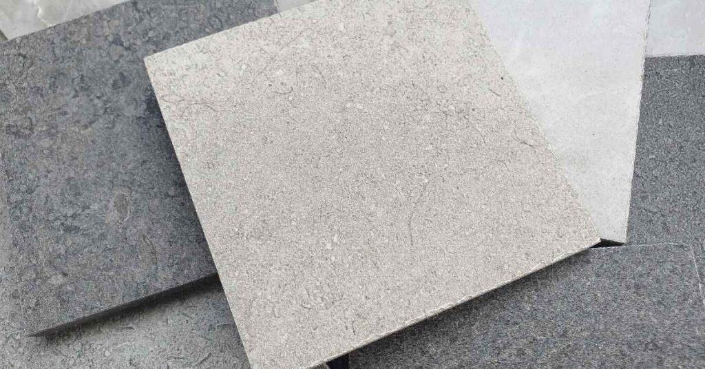 Light and dark gray concrete countertop sample tiles arranged together.