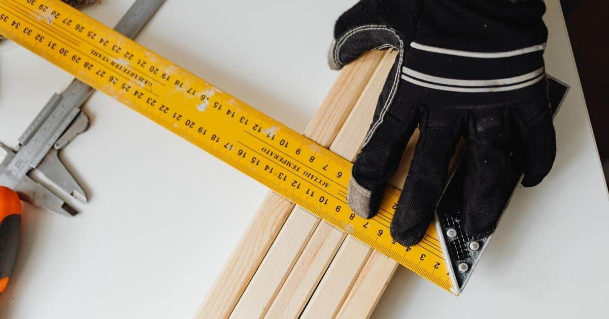 Measuring tape laid over wooden slats for layout
