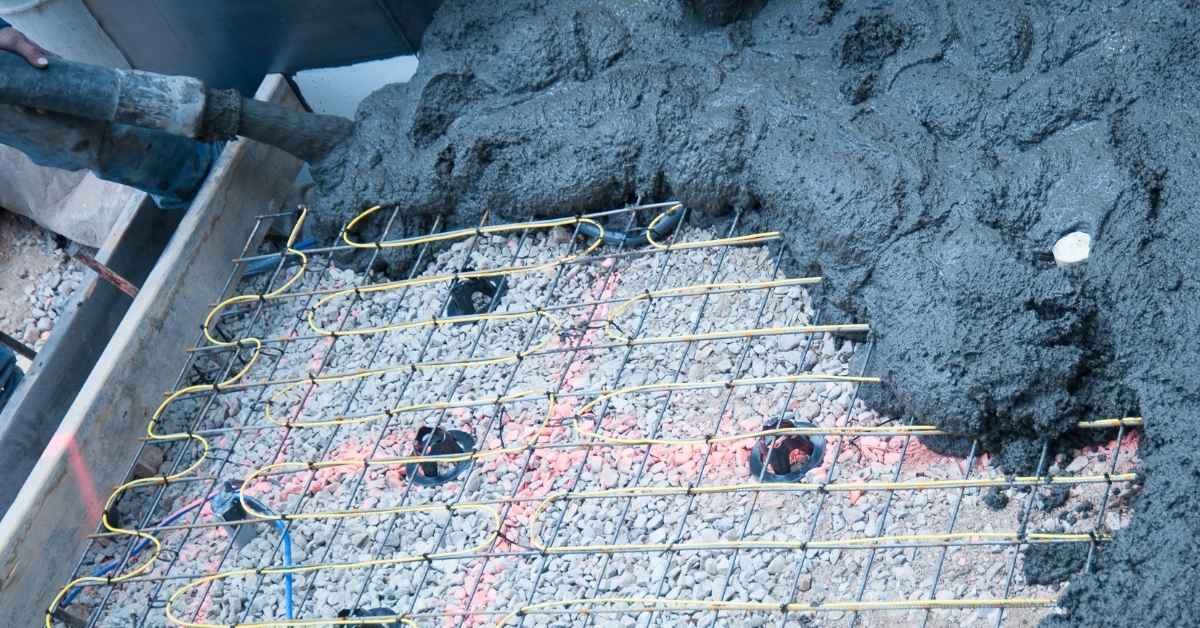 Rebar grid laid over crushed stone in a form.