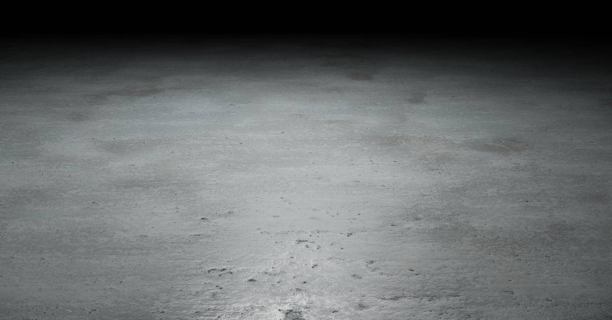 Concrete floor with mottled gray stain and subtle texture.