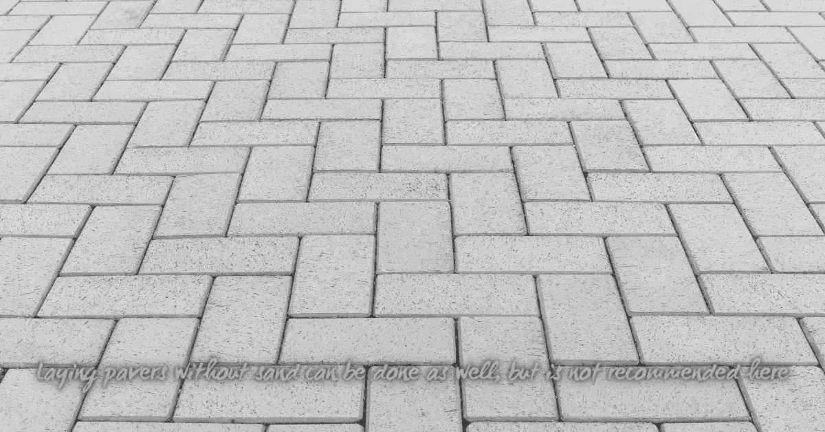 Close-up view of interlocking concrete pavers in herringbone pattern
