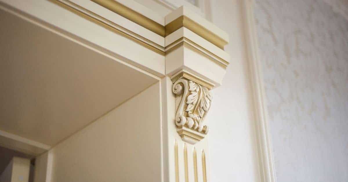Decorative cream-colored door casing with ornate corner detail