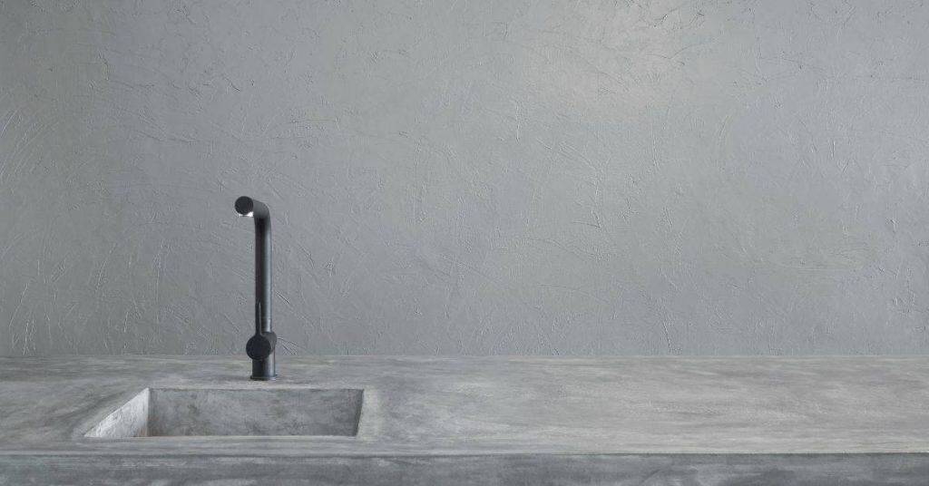 Minimalist concrete countertop with sink and black faucet