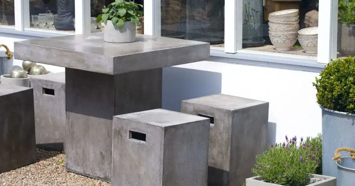 Concrete outdoor table and stools on gravel surface