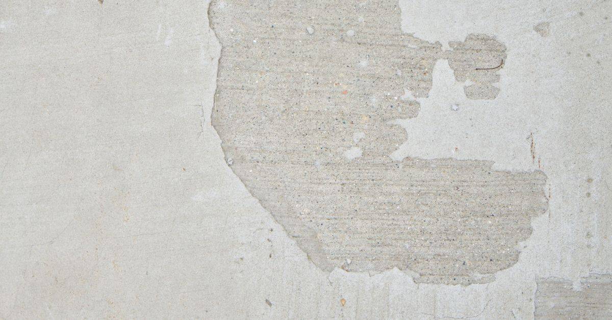 Concrete wall with spalling surface damage patch