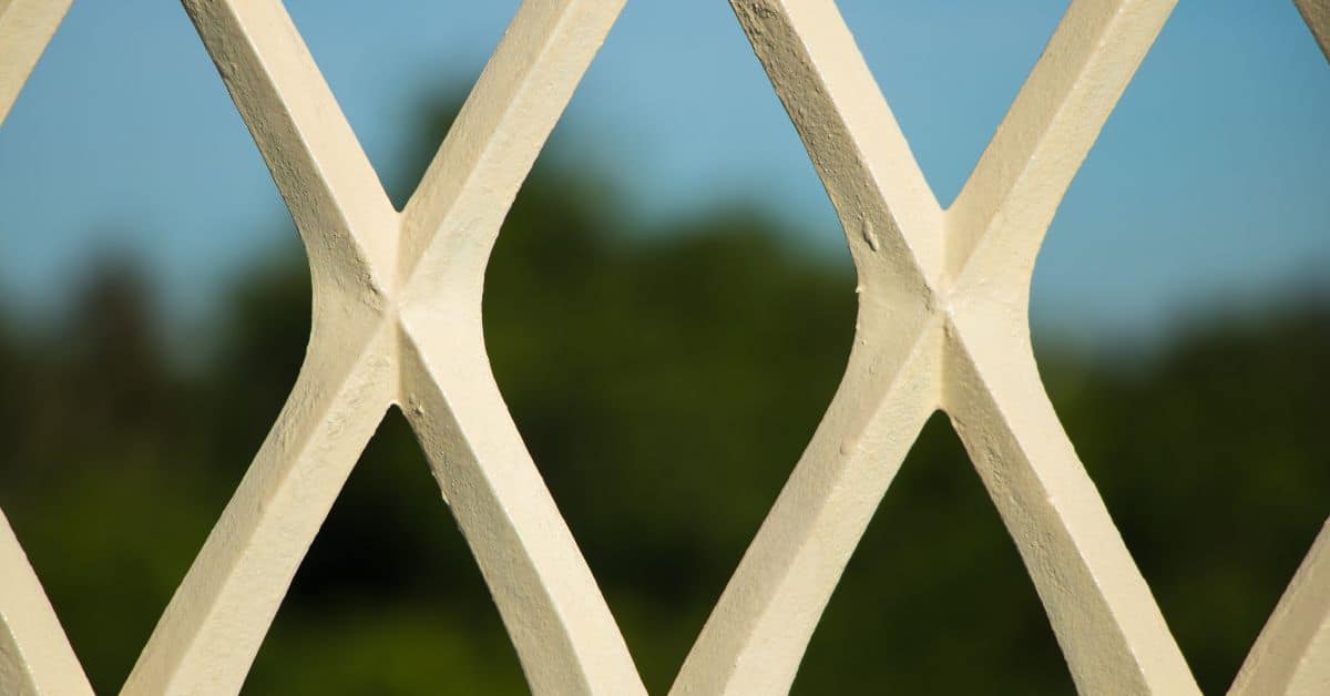Close-up of painted metal grill with diamond pattern