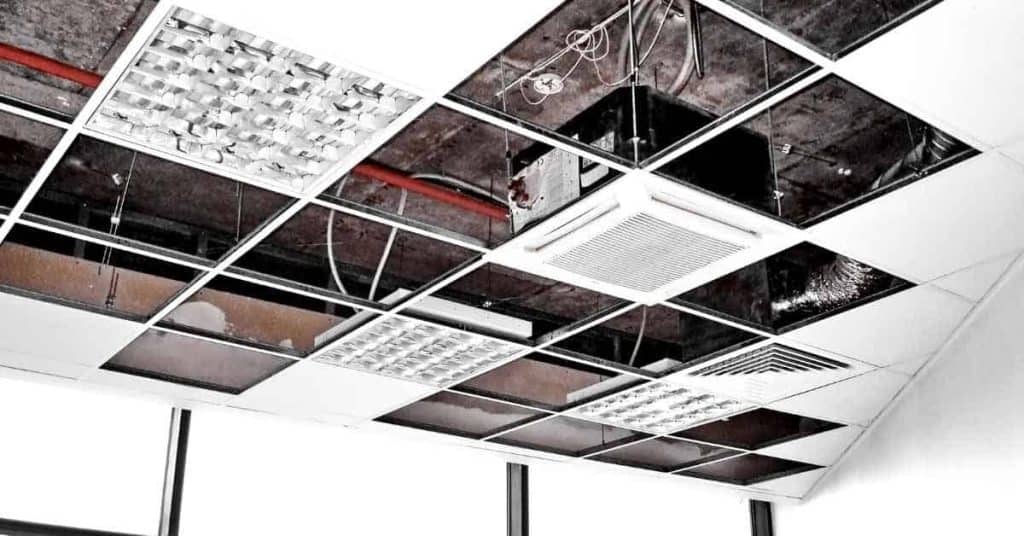 Drop ceiling grid with missing and installed tiles