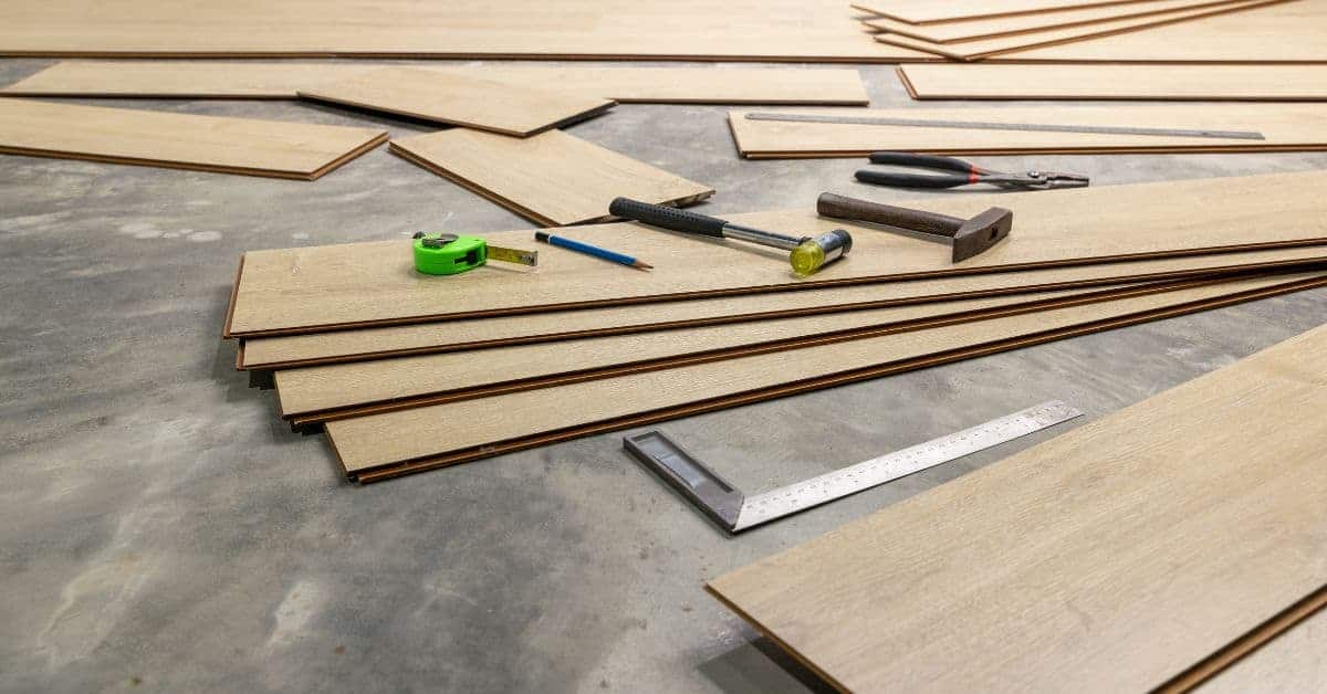 wooden planks scattered on floor with hammer tape measure and square