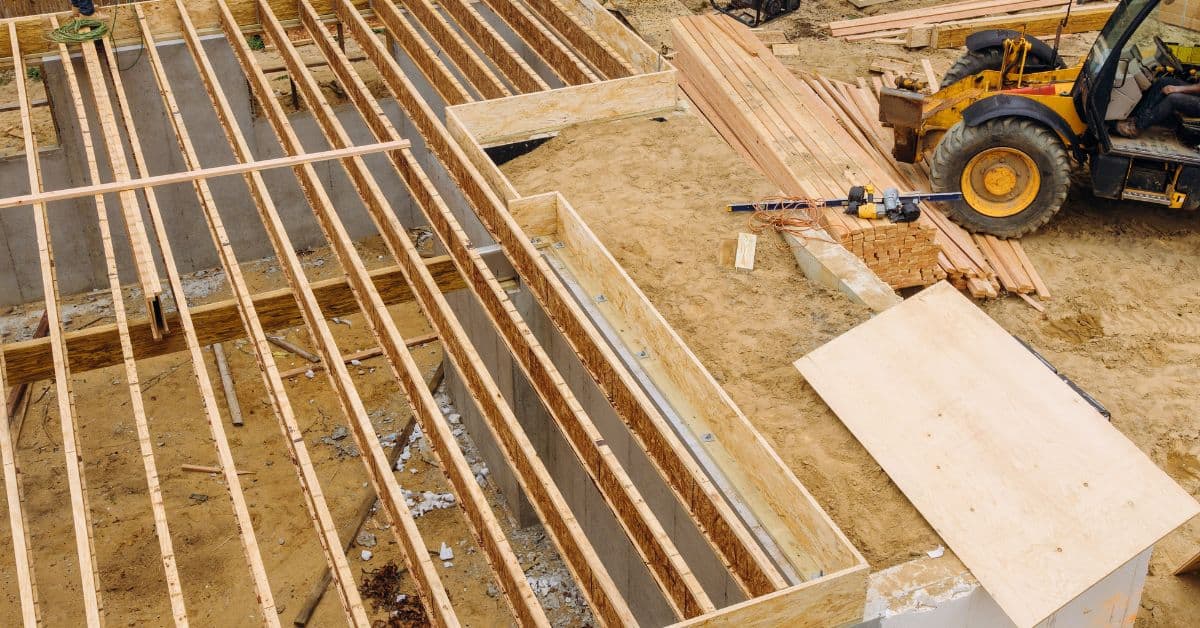 Wood floor joists framing over concrete foundation