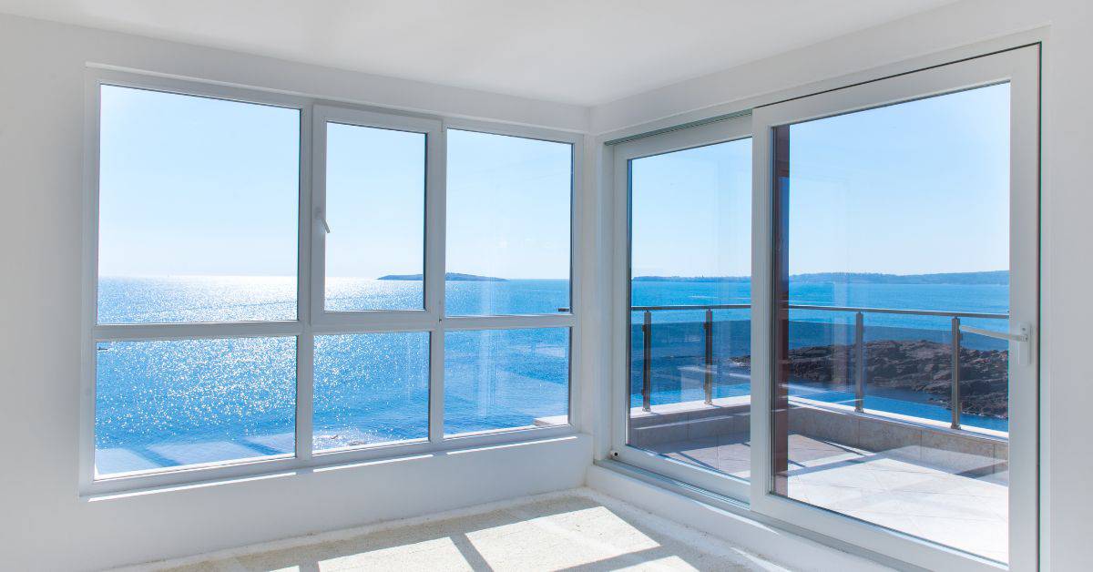 Bright corner basement windows overlooking ocean view