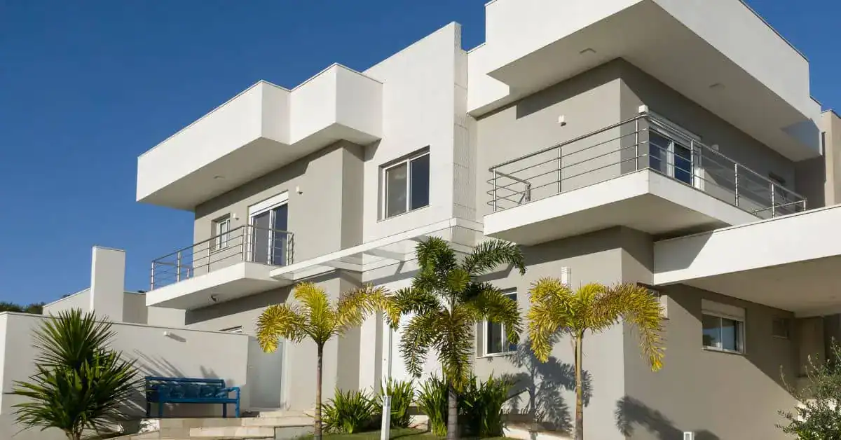 Modern home with flat roof balconies and metal railings