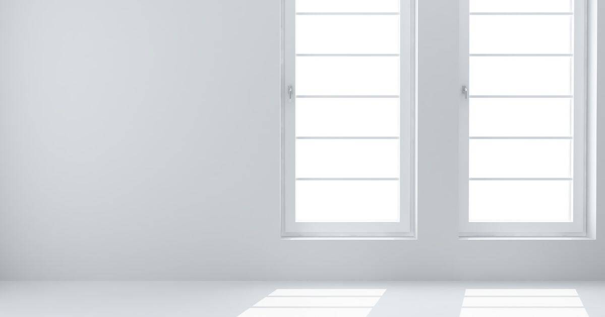Two clean modern white windows on pale white wall