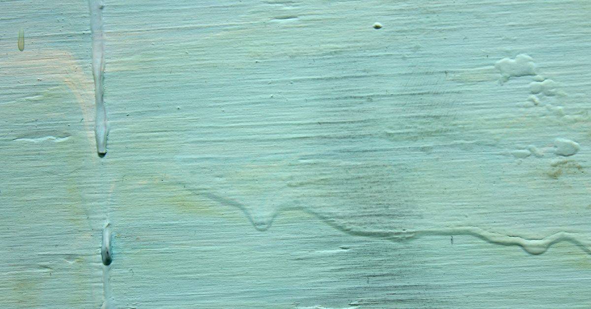 Close-up of wood surface with paint drips and texture