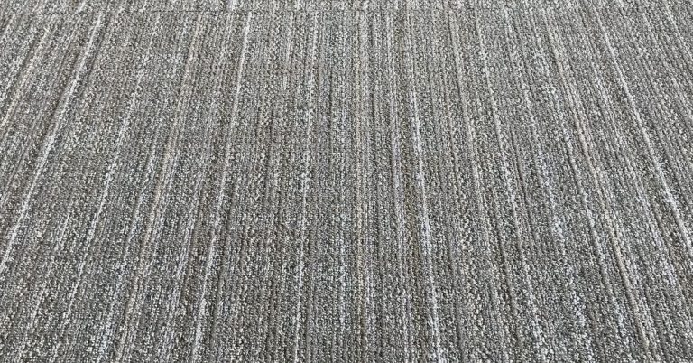 Close-up of textured commercial carpet with striped pattern
