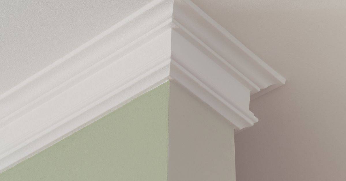 White crown molding inside corner with two different wall colors
