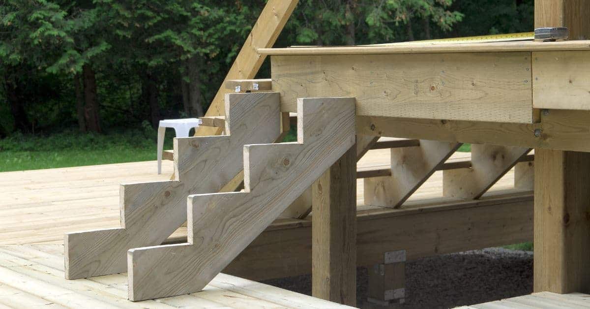 Wooden deck stairs with stair stringers and deck framing