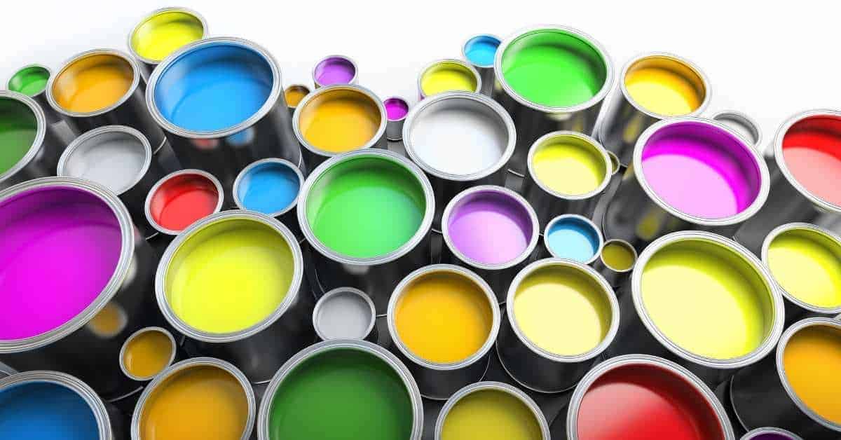 Open paint cans filled with various bright colors