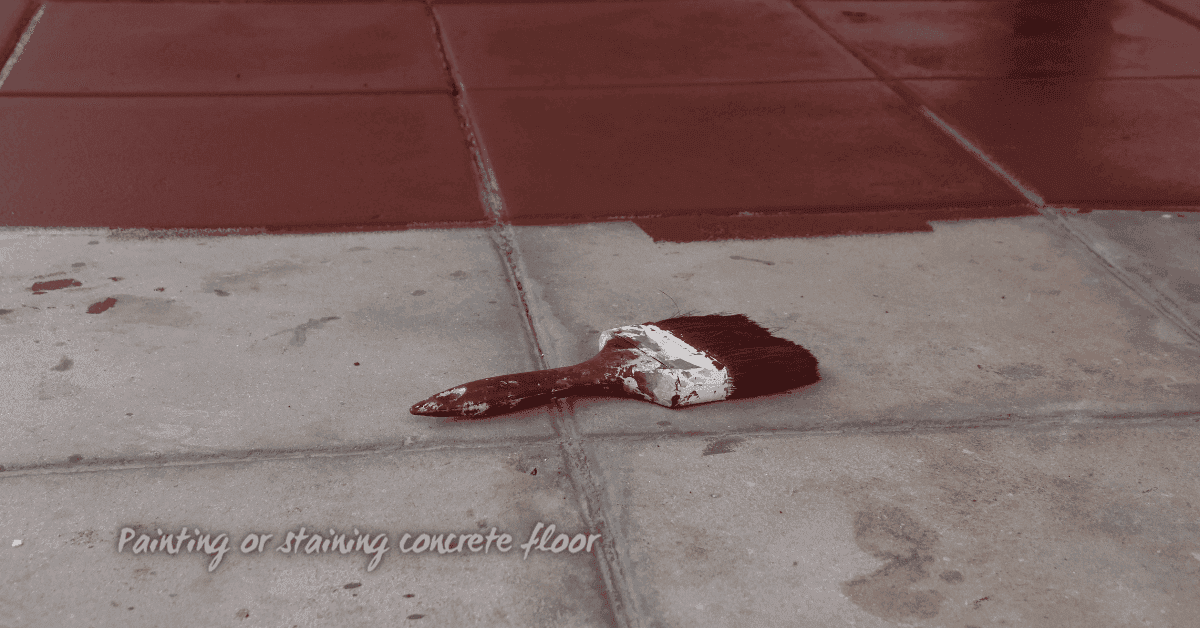 Paintbrush lying on unpainted tile near painted red tiles