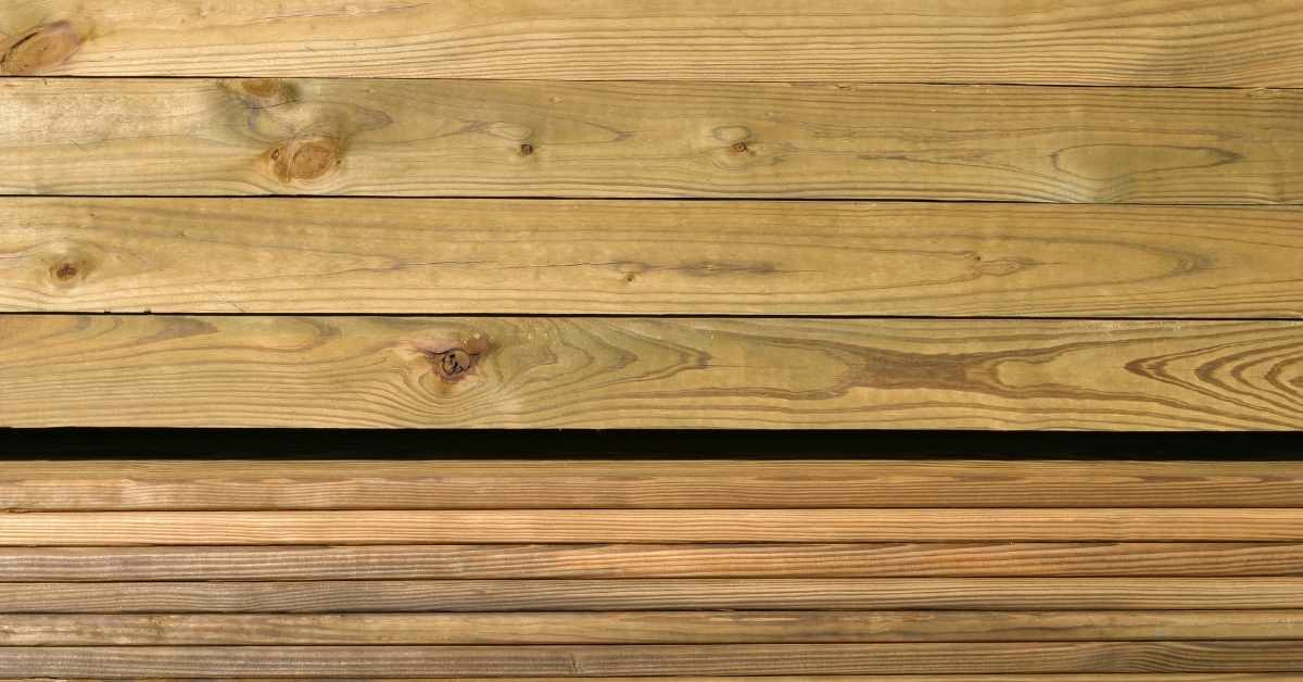 stack of light greenish and natural wood planks stacked horizontally