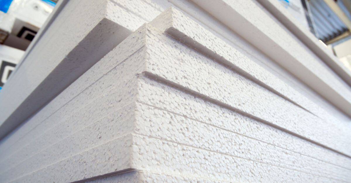 Stack of white foam insulation boards piled closely