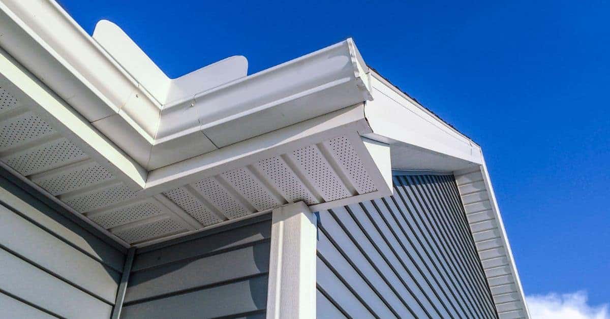 White exterior trim on house roofline under bright blue sky