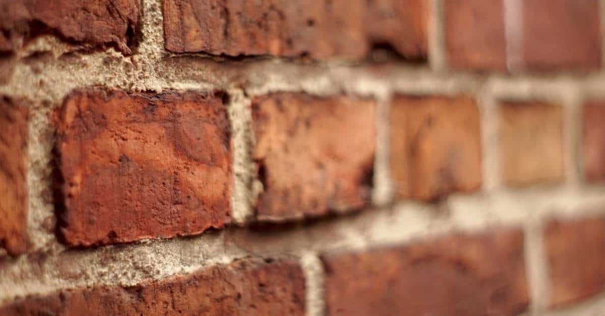 Closeup of red brick wall with mortar joints