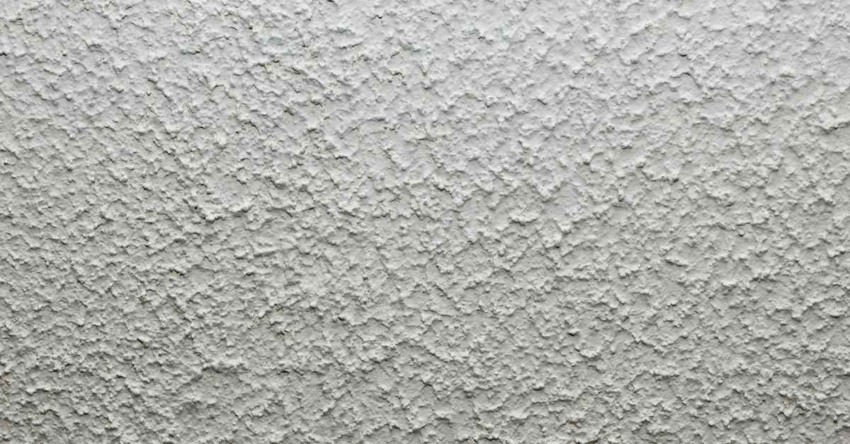 Close-up of rough textured gray stucco surface