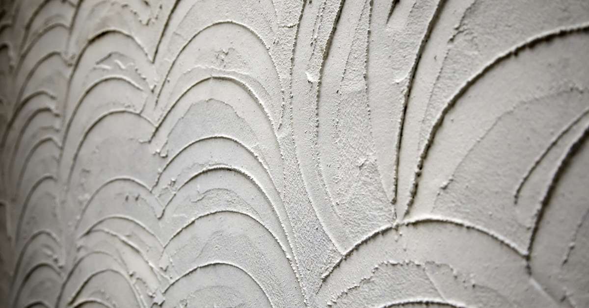 Close-up of textured white stucco wall surface