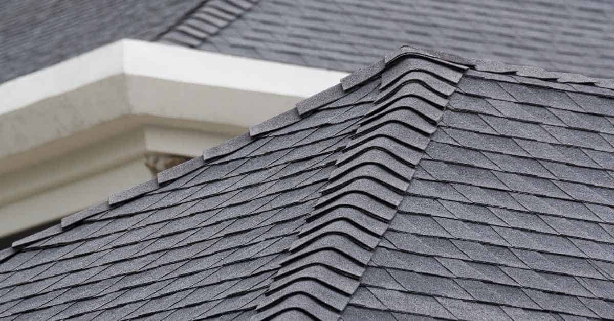 Close-up of asphalt shingle roof ridge with overlapping shingles