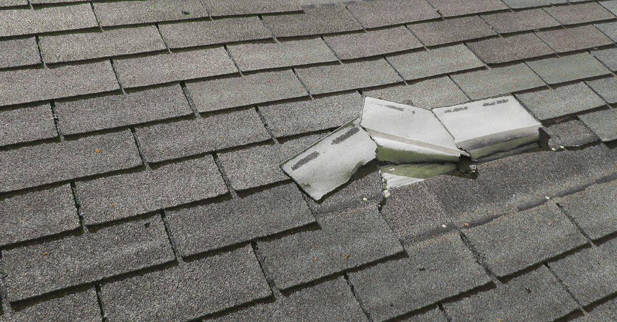Roof shingles with damaged and broken tiles