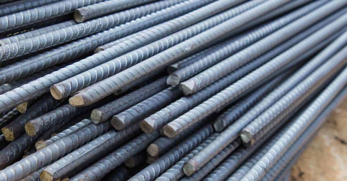 Close-up of stacked steel rebar rods with ribbed texture