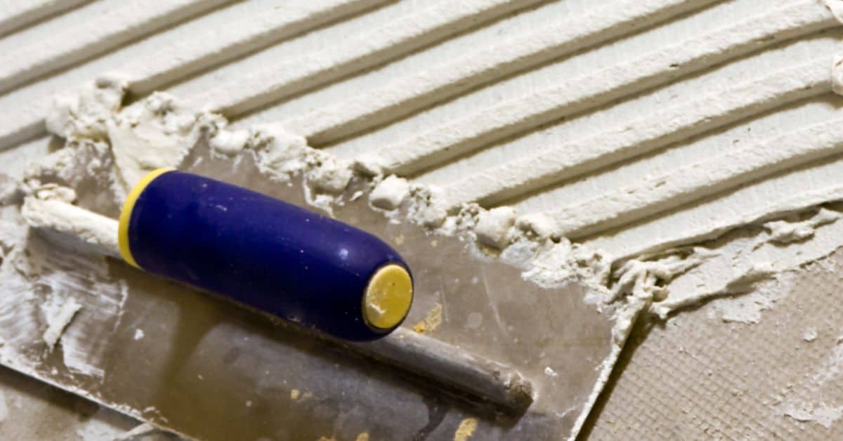 Trowel spreading thinset over cement board seams