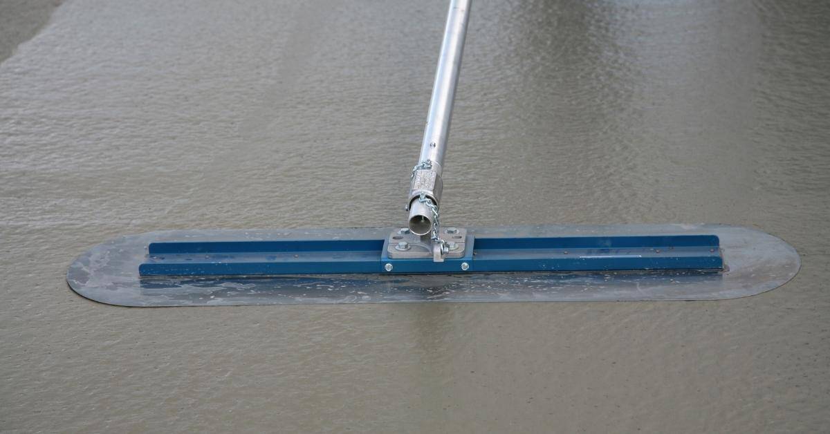 Concrete float tool smoothing wet concrete surface