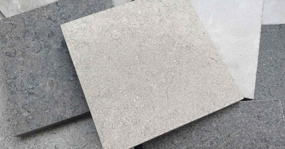 Close-up of various textured stone tile samples overlapping