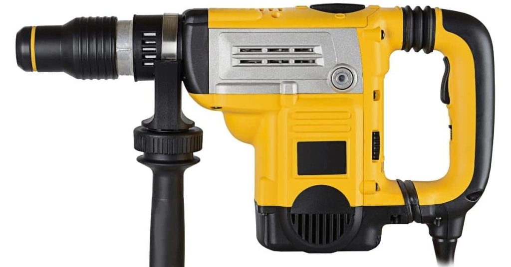 Yellow and black electric hammer drill on white background