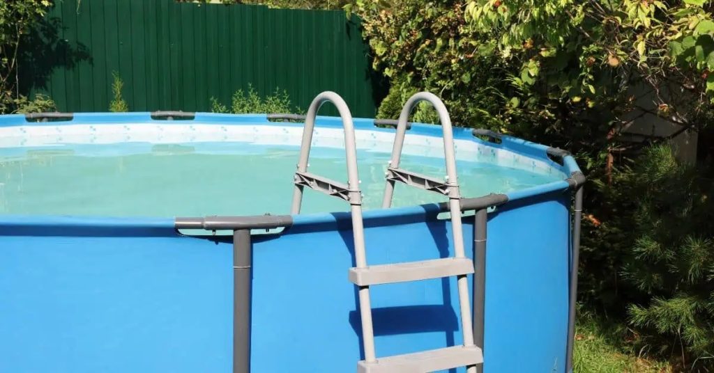 Above ground pool with ladder in backyard