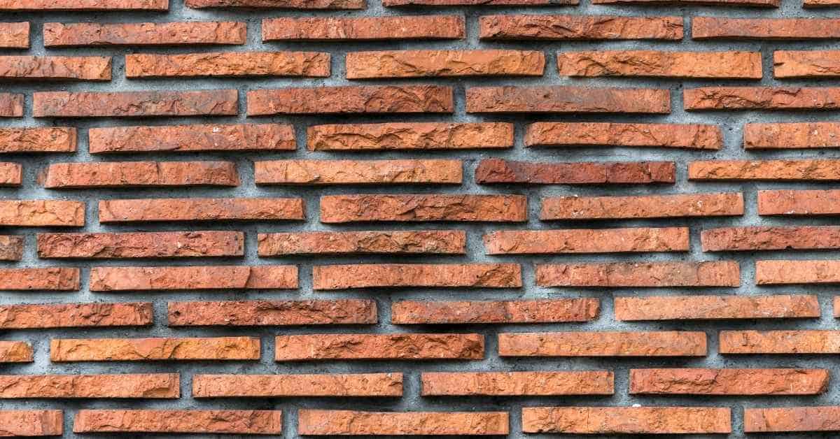 Thin red brick wall with staggered horizontal pattern