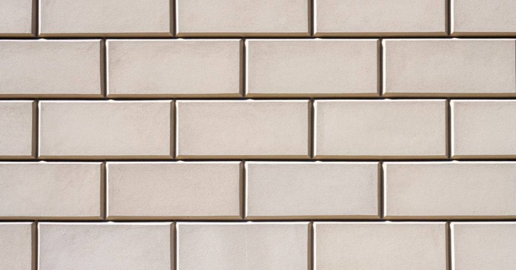 Close-up of beige subway tile wall with grout lines