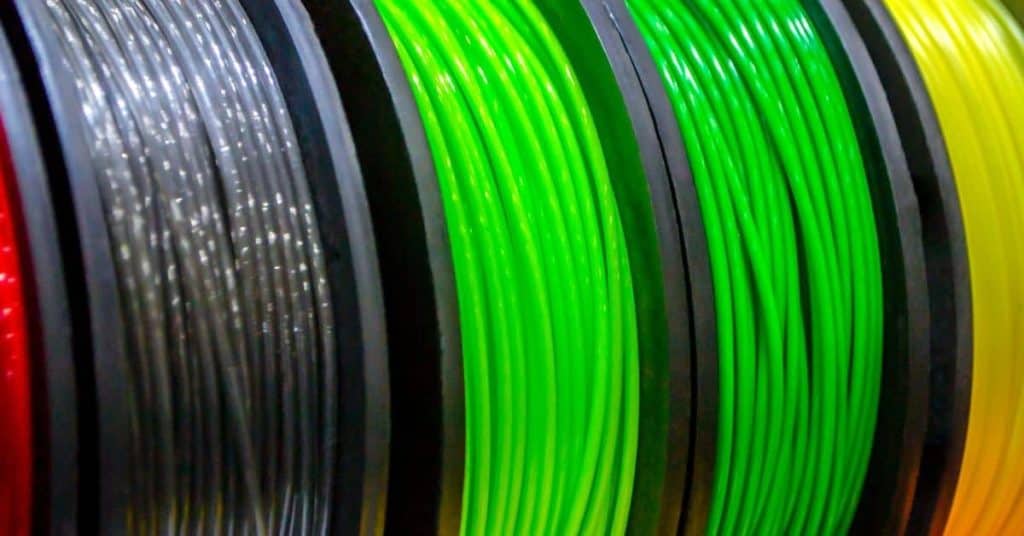 Close-up of colorful plastic filament spools in various colors