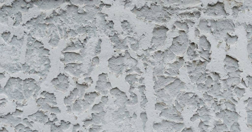 Close-up of gray rough textured stucco wall surface