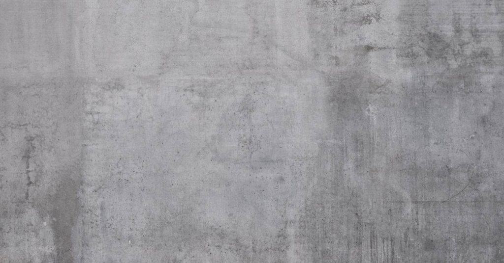 close-up of grey concrete wall texture with stains and marks