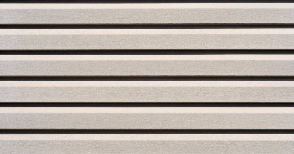 Close-up of horizontal lap siding painted beige