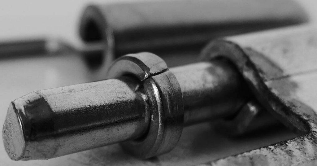 Close-up of metal rod with cracked retaining ring