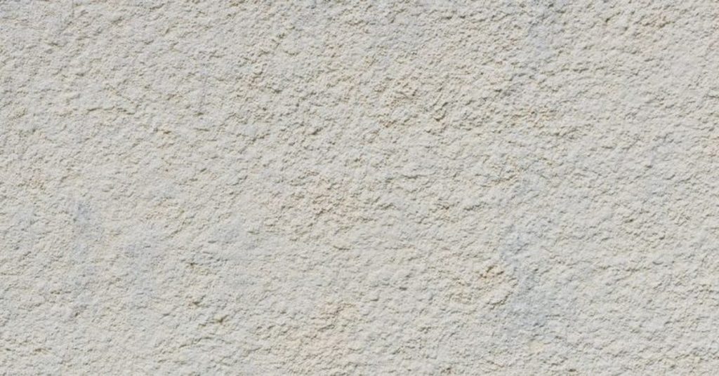 Close-up of rough light gray stucco wall texture