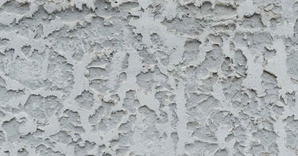 Close-up of rough textured gray stucco wall surface