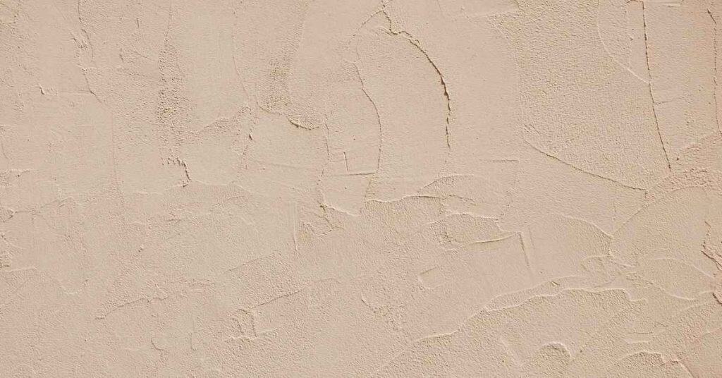 Close-up of textured beige stucco wall surface