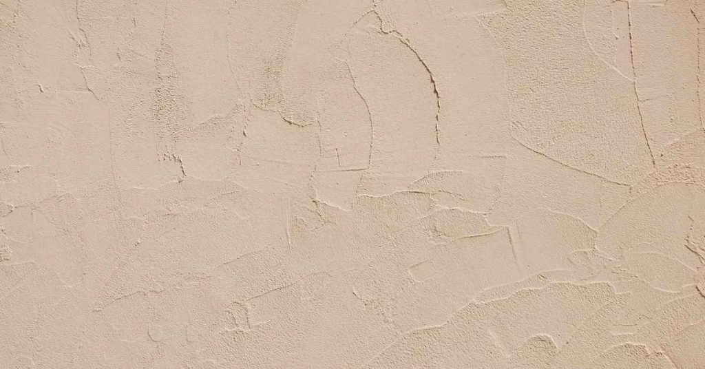 Close-up of textured stucco wall finish surface