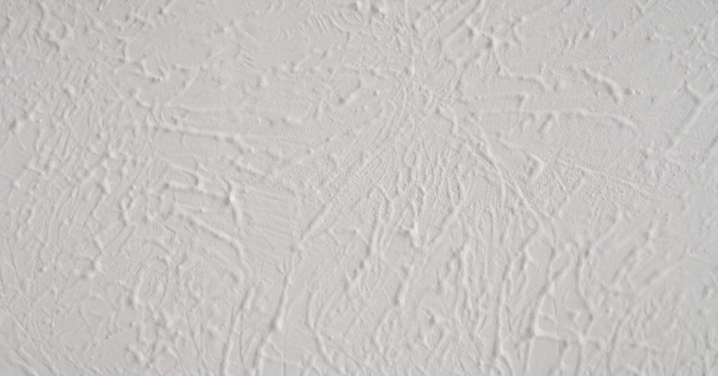 Close-up of textured white plaster wall finish