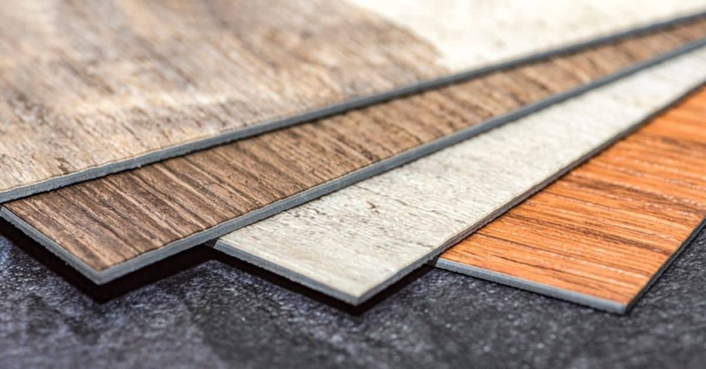Close-up of various vinyl flooring plank samples in different wood tones