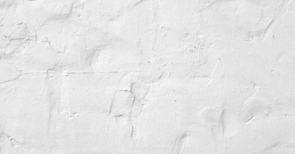 Close-up of white plaster wall with textured surface